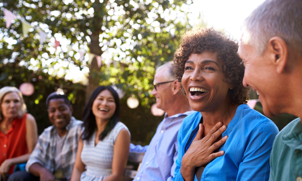 A group of mature friends having a discussion outside.