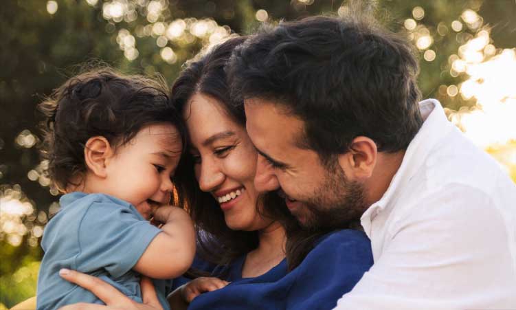 Family outdoors, hugging