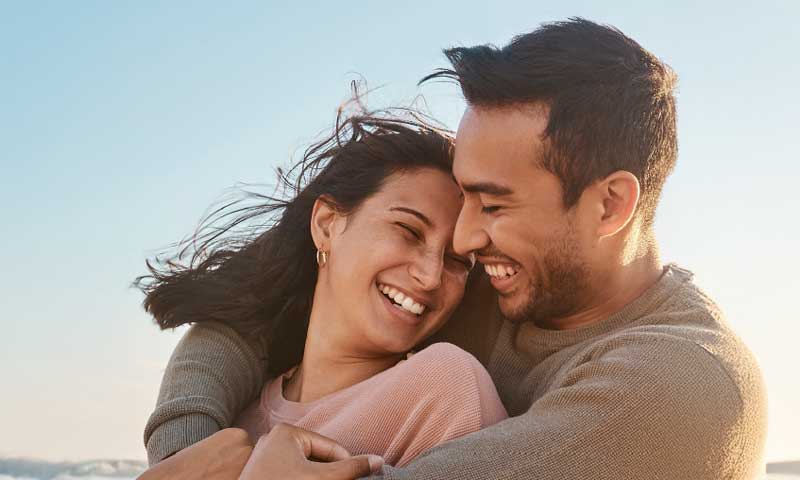 Two people hugging each other