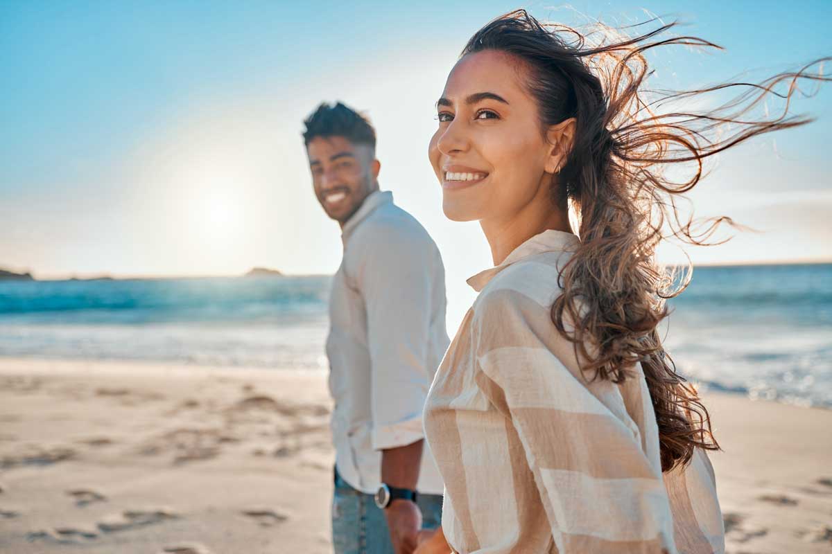 Two people walking on the beach